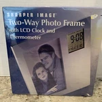 New Sharper Image Silver Photo Frame 4X6 Two-way With Lcd Clock & Thermometer. Fixed Price $19.95.