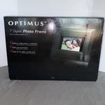 7" Optimus 16-468 16MB 480X234 Widescreen Digital Wood Photo Frame (black). Fixed Price $22.00.