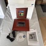Brookstone 6" Lcd Digital Wood Frames. Fixed Price $30.00.