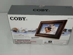 Coby 7" Widescreen Digital Photo Frame With MP3 Player DP-767. Fixed Price $59.99.