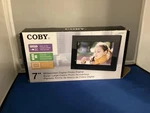 Coby DP-769 Brand New 7" Widescreen Digital Photo Frame With MP3 Playback. Fixed Price $30.00.