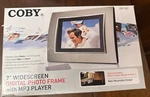 Coby 7" Widescreen Digital Photo Frame With MP3 Player DP-767. Fixed Price $24.99.