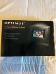 7" Optimus 16-468 16MB 480X234 Widescreen Digital Wood Photo Frame (black). Fixed Price $25.99.