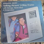 Sharper Image Talking Picture 2-WAY Frame Alarm Clock Message Temp Silver. Fixed Price $19.00.