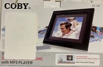New Coby 7" Widescreen Digital Photo Frame With MP3 Player DP-768. Fixed Price $29.99.