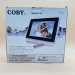 Coby DP-769 7" Widescreen Digital Pic. Frame MP3 Playback Changeable Faceplate. Fixed Price $24.99.